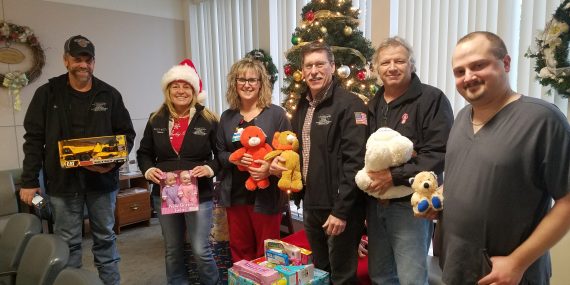 Representatives from the Cattaraugus County Town Highway Superintendents Association present gifts for the youngest emergency department patients at Bertrand Chaffee Hospital